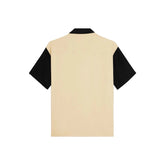 Beige and black shirt on a light gray background