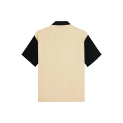 Beige and black shirt on a light gray background