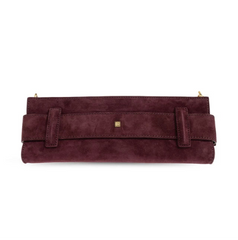 A burgundy suede clutch bag with a wide strap across the front, a small gold square logo plaque, and gold-tone zipper pulls, shown against a plain white background.