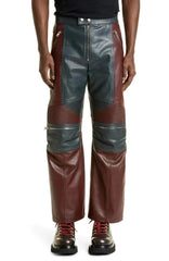 Brown and gray leather pants worn by a person on a white background