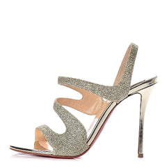 Silver high-heeled shoe with open design on a white background