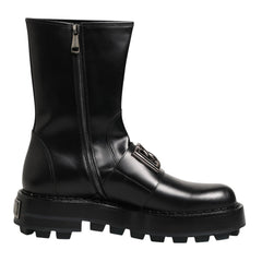 A black leather ankle boot with a side zipper, lace-up front, and chunky lug sole, shown against a plain white background.