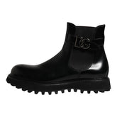 Black rain boot with a brand logo on a white background