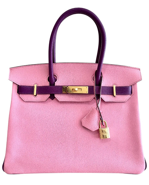 Pink handbag with gold hardware on a white background