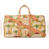 Travel bag with tropical pattern and brown leather straps on a white background