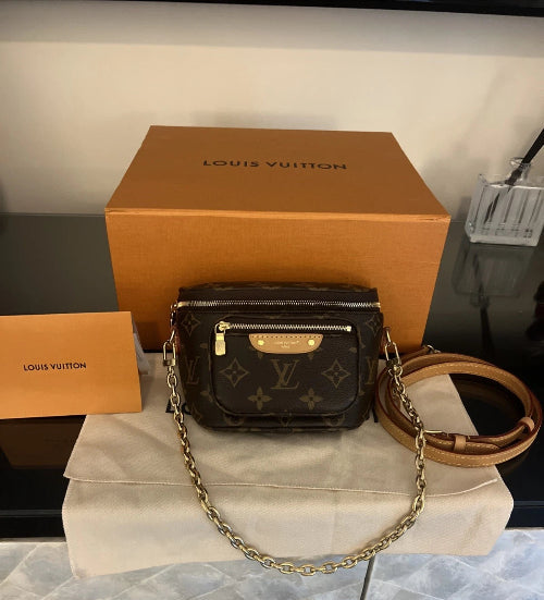 Louis Vuitton handbag with monogram pattern and brown strap, displayed on a white surface with a Louis Vuitton box in the background.