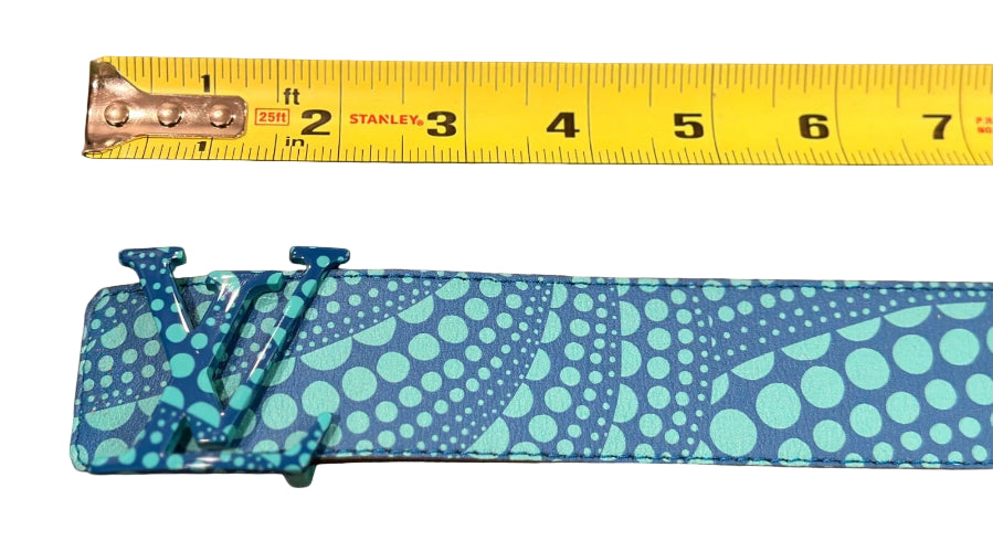 Blue patterned belt with a measuring tape showing its width on a brown surface