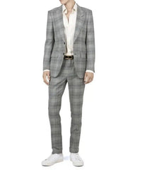 A man wearing a gray and white plaid suit with a white shirt and white sneakers, shown from the neck down against a plain white background.