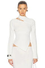Woman wearing a white long-sleeve top with cut-out design on a white background