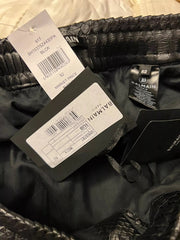 Black leather jacket with visible brand tags and labels.