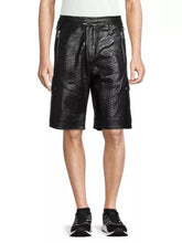 A pair of black Balmain snakeskin leather shorts with an adjustable waistband, zipper closure, and a quilted pattern. The shorts are designed for men and displayed against a white background.