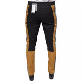 Black and brown pants with a visible brand tag on a white background