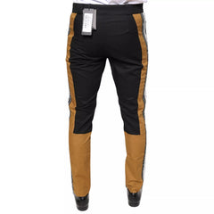 Black and brown pants with a visible brand tag on a white background