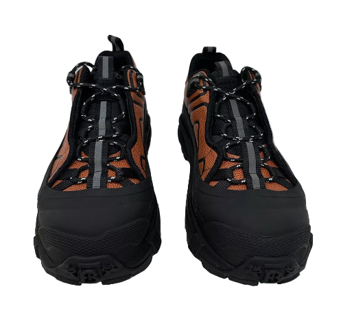 Pair of black and brown hiking boots on a light gray background
