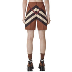 Person wearing a brown and beige striped skirt on a white background