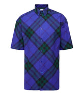 Blue and green plaid shirt on a light gray background