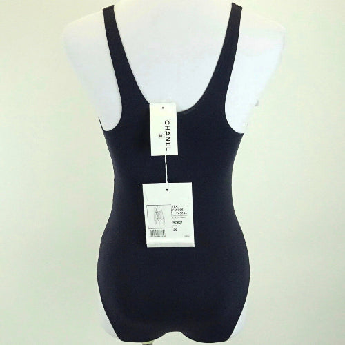 Black swimsuit on a mannequin with Chanel branding.