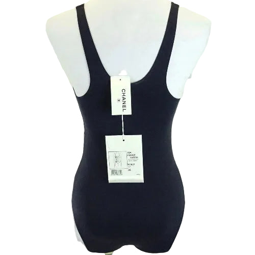 Black swimsuit on a mannequin with Chanel branding.