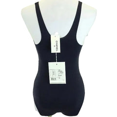 Black swimsuit on a mannequin with Chanel branding.
