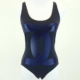 Black and blue swimsuit on a mannequin against a white background