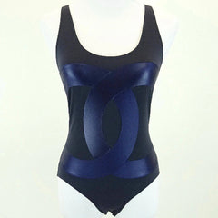 Black and blue swimsuit on a mannequin against a white background