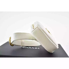 White Chanel belt on a black platform with a white background