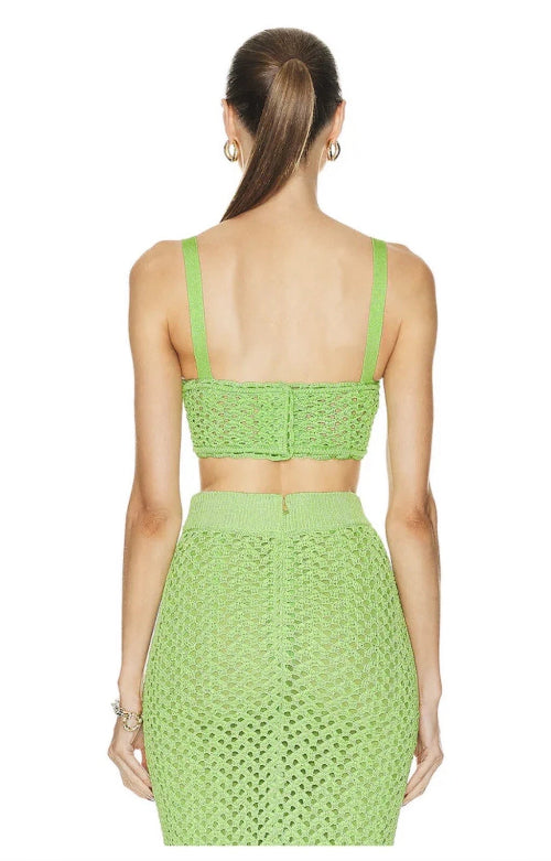 Green crochet top and skirt set on a white background