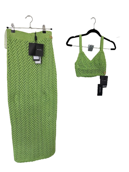 Green crochet skirt and top on hangers against a white background