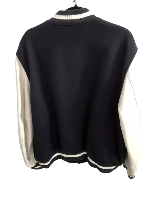 Black and white jacket on a hanger against a neutral background