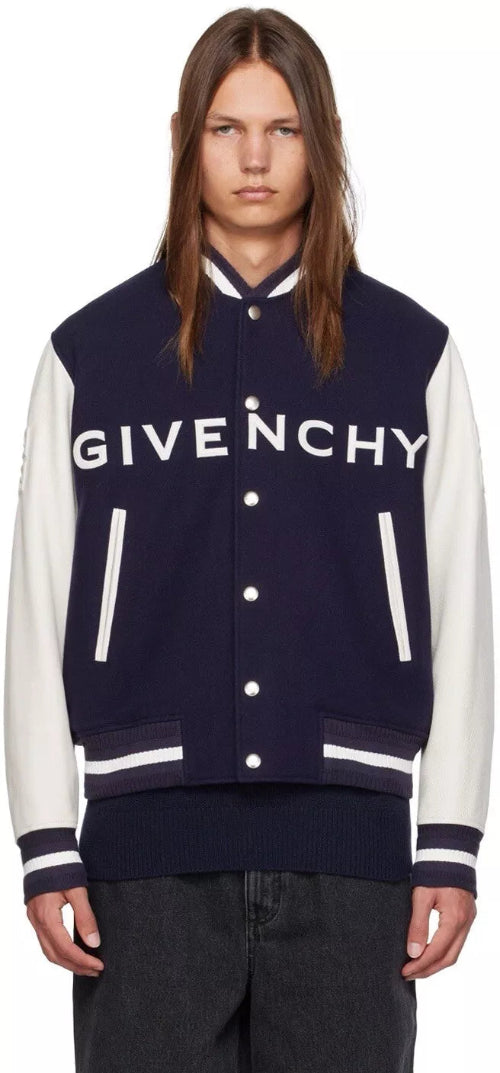 Person wearing a Givenchy varsity jacket on a white background