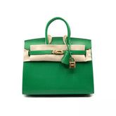 A green HERMÈS Birkin handbag with a chevre chamkila leather exterior, gold hardware, and a white calfskin leather trim. Includes a gold padlock and keys, a dust bag, and a clochette.