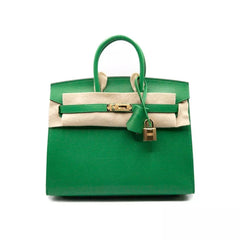 A green HERMÈS Birkin handbag with a chevre chamkila leather exterior, gold hardware, and a white calfskin leather trim. Includes a gold padlock and keys, a dust bag, and a clochette.