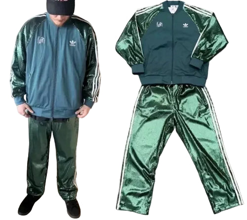 Green shiny tracksuit with Adidas logo on a gray background