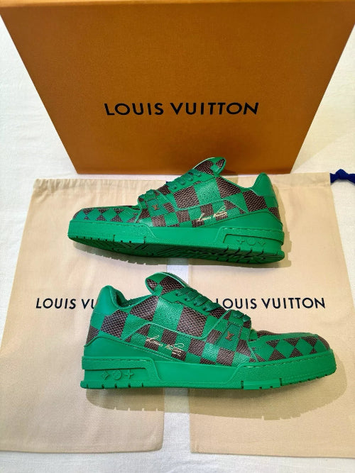 Green patterned sneakers with Louis Vuitton branding on a beige pouch and box.