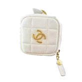 White quilted pouch with gold CC logo on a black box