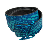 Blue patterned belt with a black interior on a beige surface