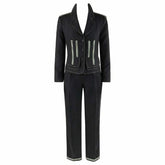 A dark charcoal gray two-piece suit featuring a tailored blazer with light gray contrast piping and zippered pockets, paired with matching straight-leg trousers.