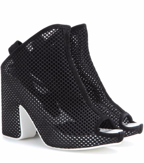 Black heeled shoes with open toes on a white background