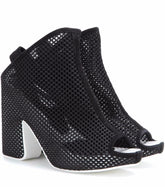 Black heeled shoes with open toes on a white background