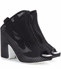 Black heeled shoes with open toes on a white background