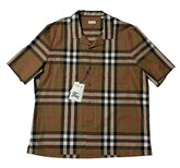A short-sleeve Burberry plaid button-up shirt laid flat on a white background, featuring the classic tan, beige, black, and red check pattern with a visible hangtag.