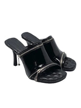 Black high-heeled sandals on a white background