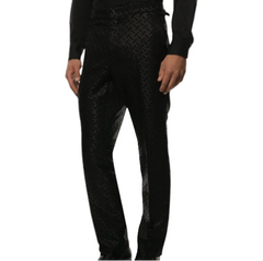 Black patterned trousers with a subtle geometric jacquard weave, shown on a model from the waist down against a light gray background.