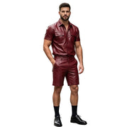 Man wearing a maroon leather outfit standing on a city street.