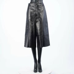 Black leather skirt on a mannequin against a white background