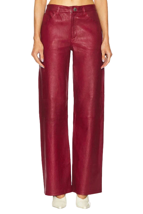 Red leather pants worn by a person on a white background