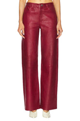 Red leather pants worn by a person on a white background