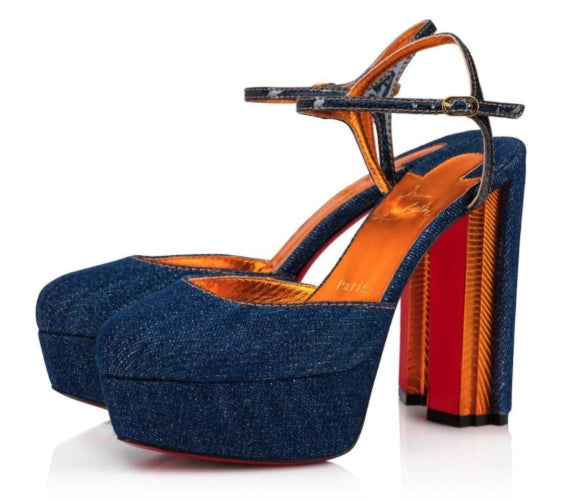 Blue denim high-heeled shoes with orange sole on a white background