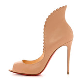 Beige high-heeled shoe with scalloped edge on a white background