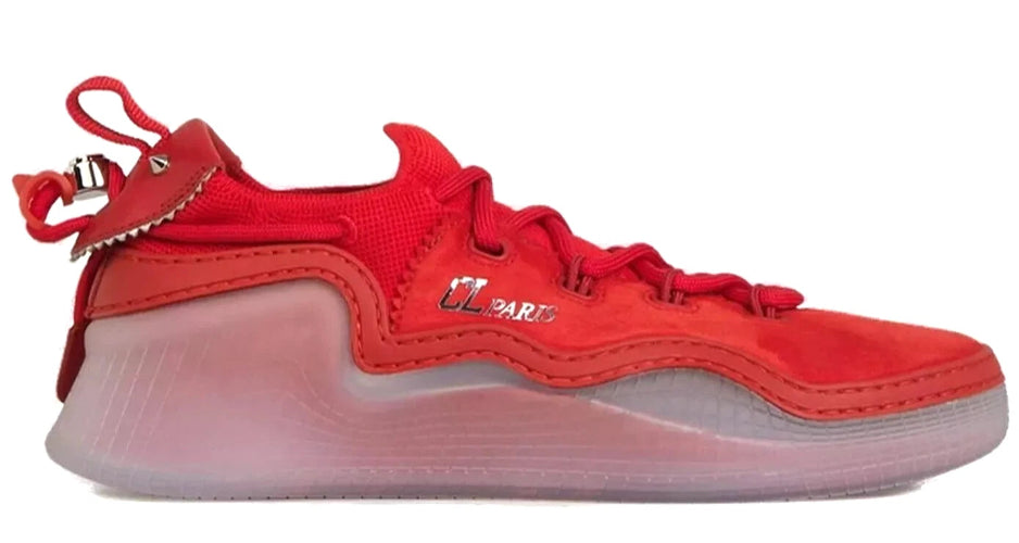 A red low-top sneaker with a translucent pinkish-tinted sole, featuring a textured red upper, red laces, and a small metallic logo on the side.